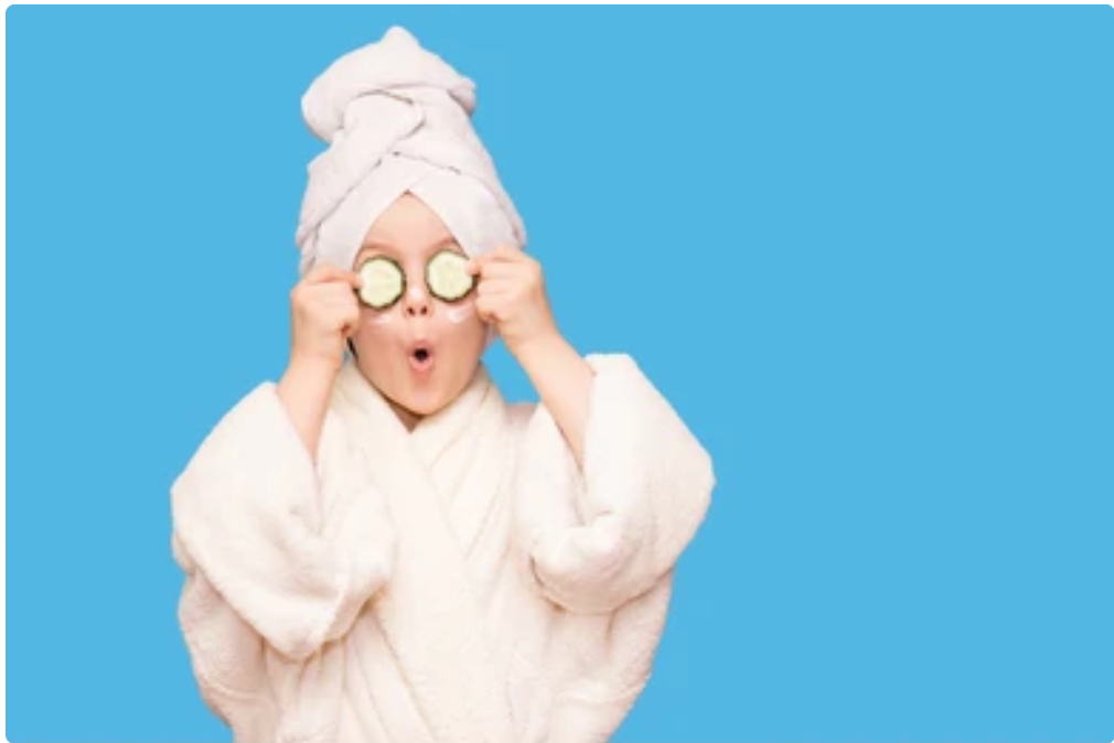 kids pamper parties in London girl holding cucumbers over eyes making fun faces